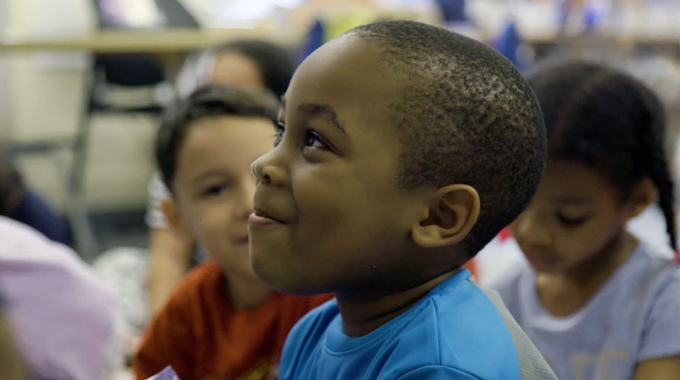 A young student smiles