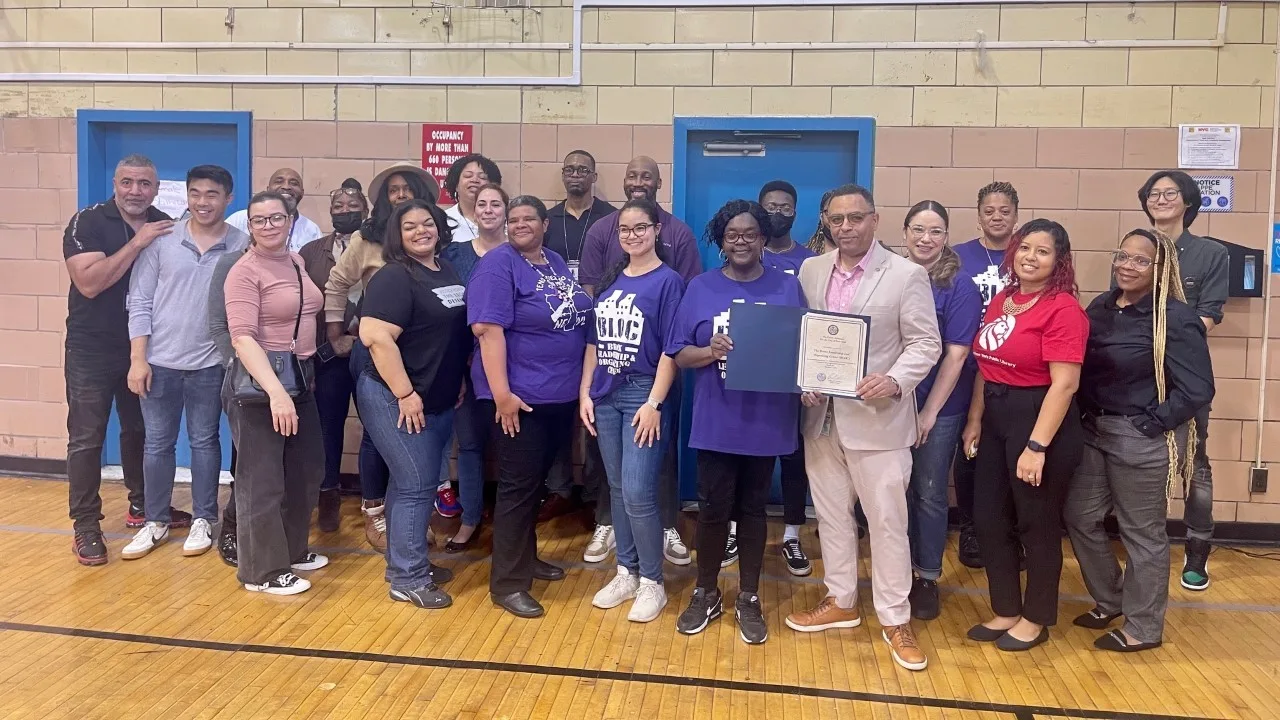 A large group of people posing in an indoor setting.
