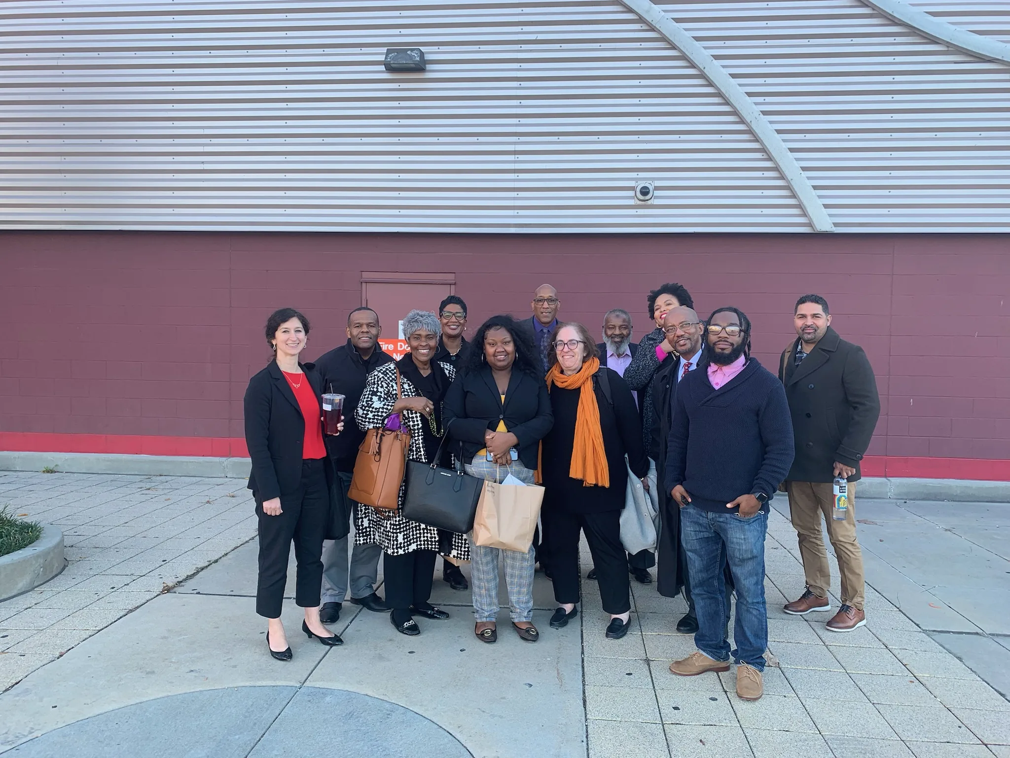 A large group of people posing for a photo in an outdoor setting.