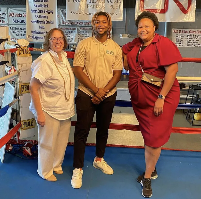 A group of three people posing for a photo in an indoor setting.